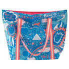 A large tote bag with neon pink handles featuring abstract art with words of advice and colorful illustrations including rainbows and stars on a blue background.