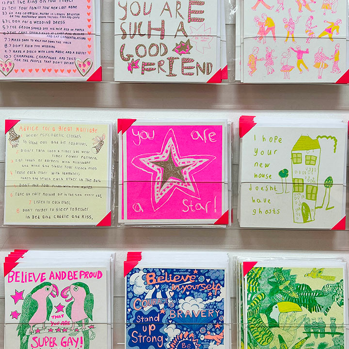 A card rack focusing on A pink and gold card with a hand drawn star and the words you are a star!