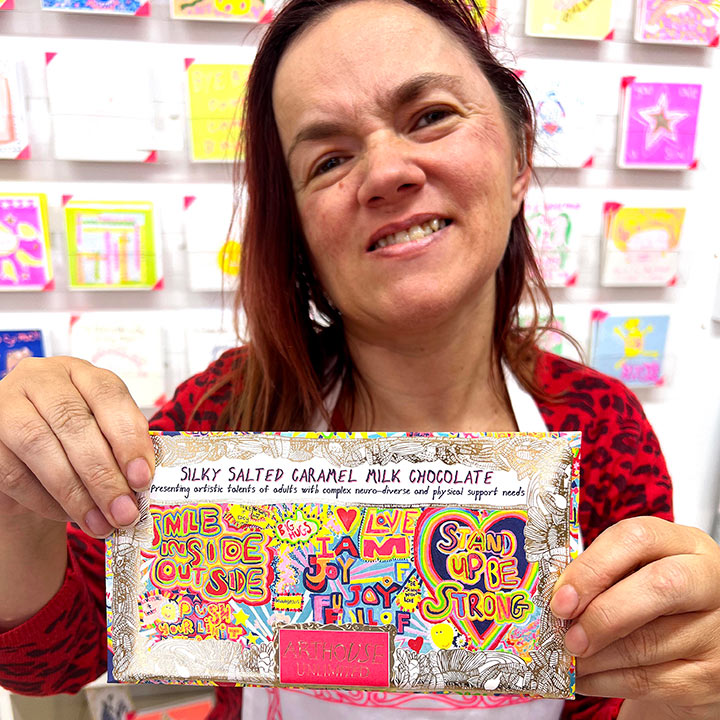Female artist holding Full of Joy, Silky Salted Caramel Milk Chocolate Bar