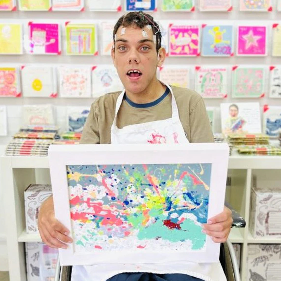 Artist holding original Spring artwork
