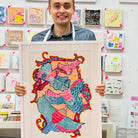Male artist holding Framed drawing of four blue, pink and yellow birds