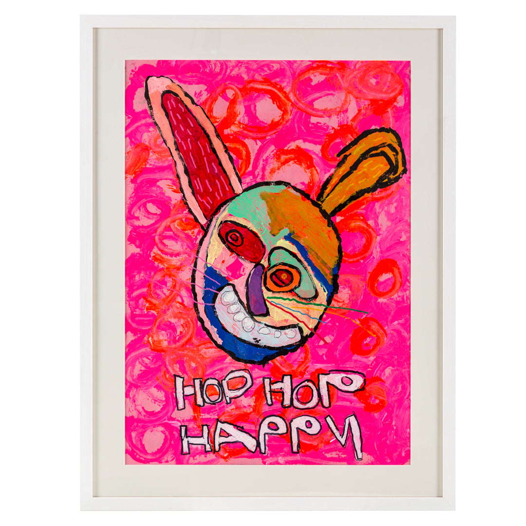 Framed painting of a bright coloured rabbit in pinks, red, green and orange with the words hop hop happy