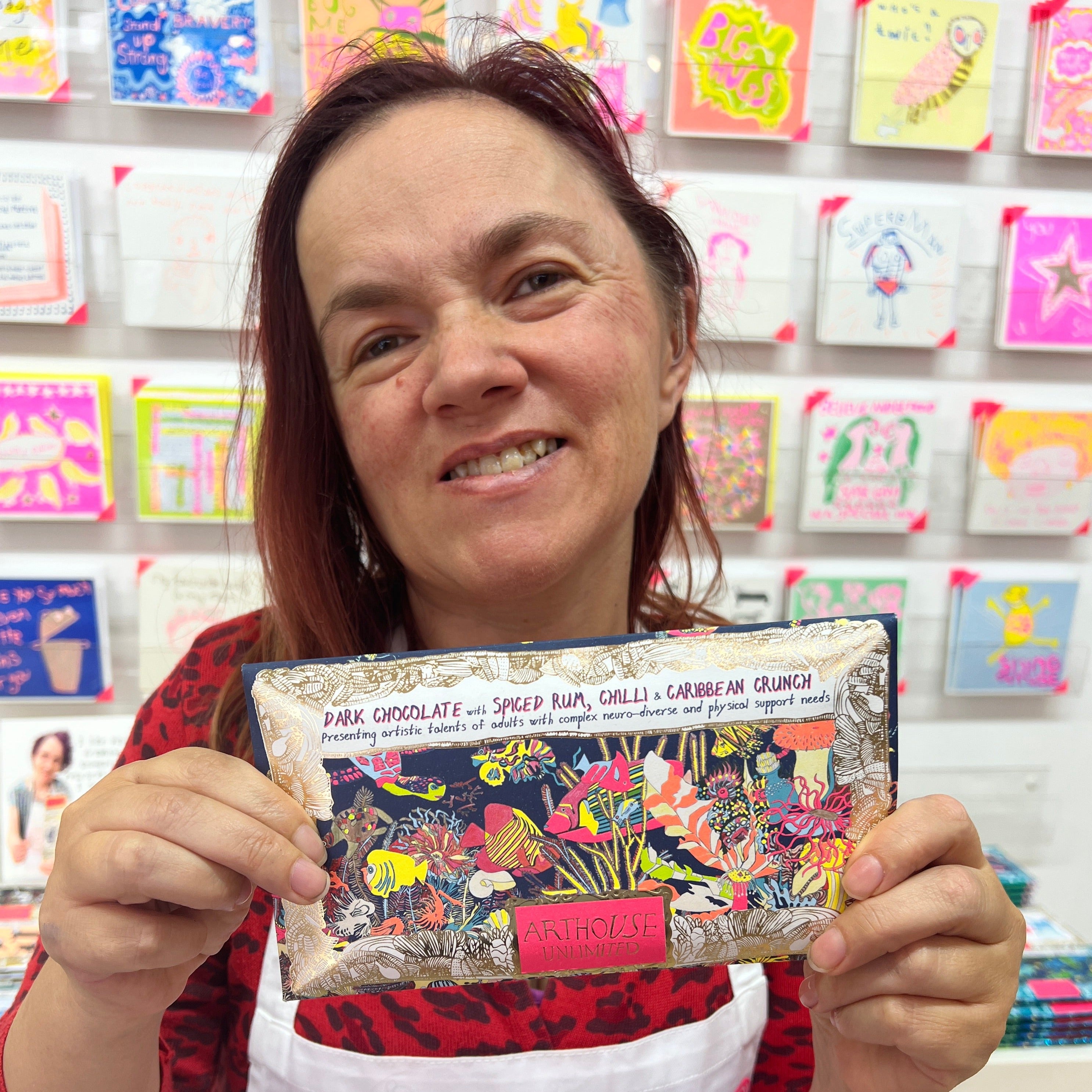 Female artist holding Angels of The Deep, dark chocolate bar with spiced rum, chilli and Caribbean crunch