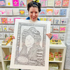 Hand drawn picture in pencil of a woman with a hat on in front of a mirror