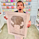 Male artist holding Hand drawn picture in pencil of a woman with a big hairdo called Jasmine