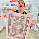 Male artist holding Hand drawn picture in pencil of a woman and a hair dryer called Francesca