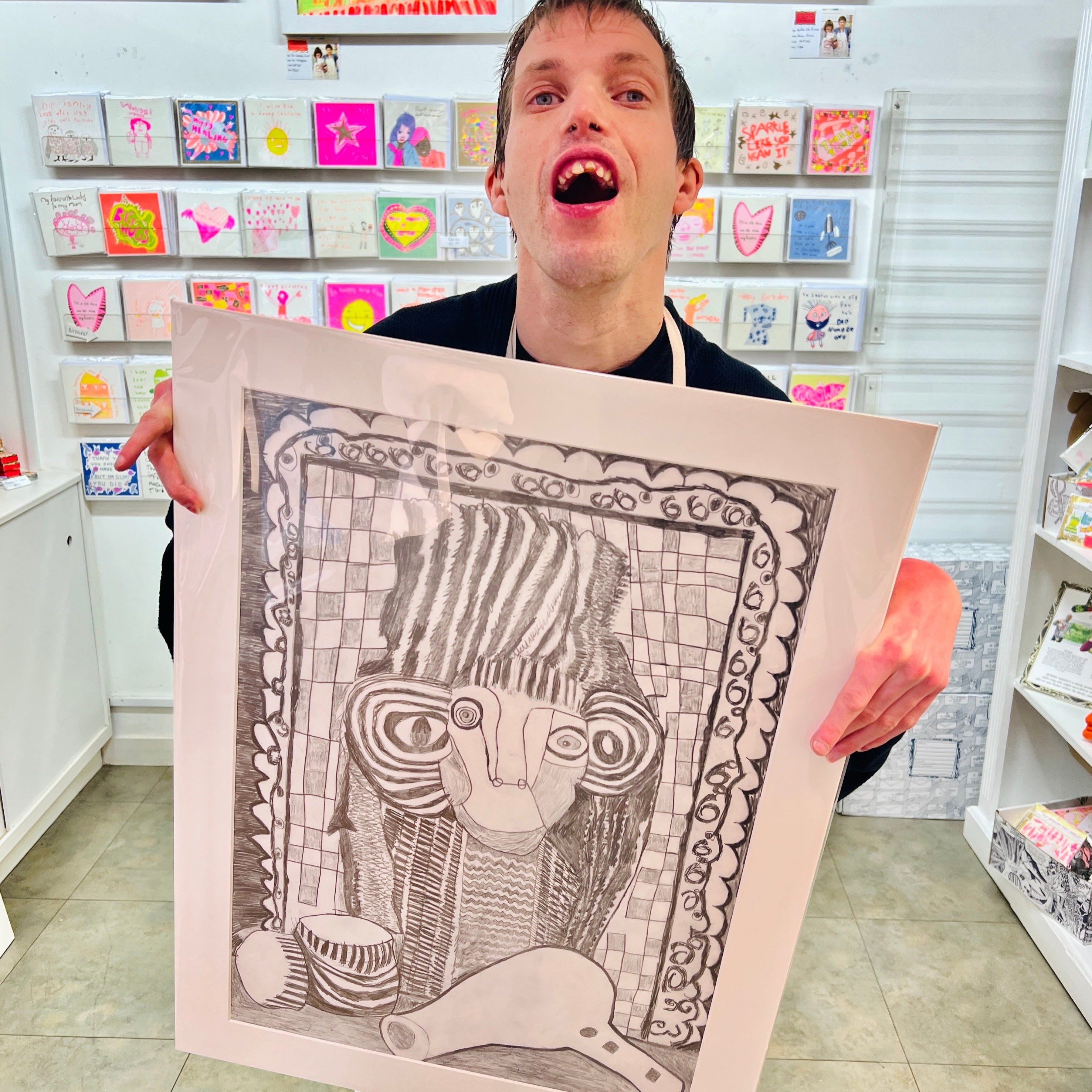 Male artist holding Hand drawn picture in pencil of a woman and a hair dryer called Francesca