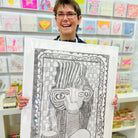 Female artist holding Hand drawn picture in pencil of a woman and a hair dryer called Francesca