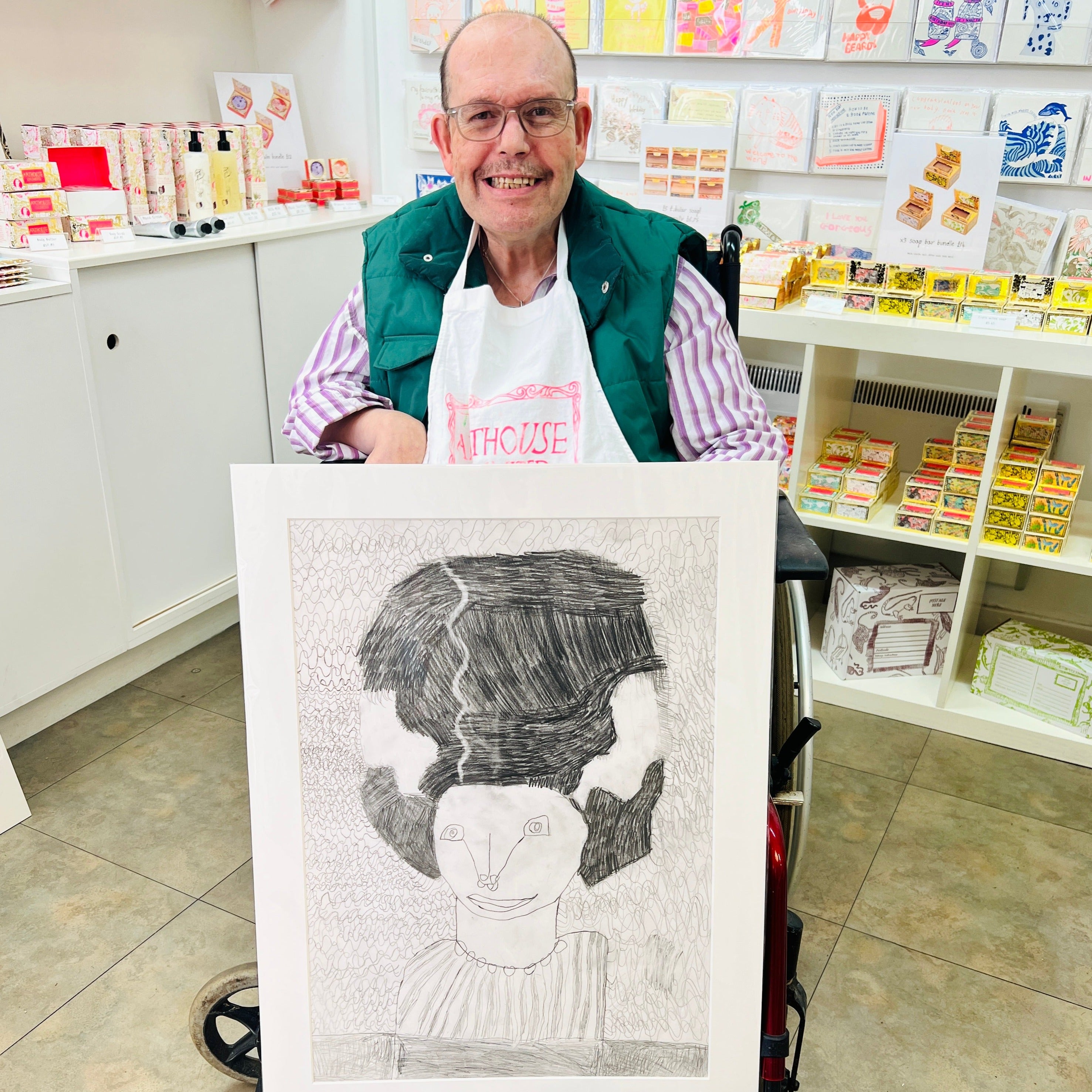 Male artist holding Hand drawn picture in pencil of a woman with a big hairdo called Jasmine