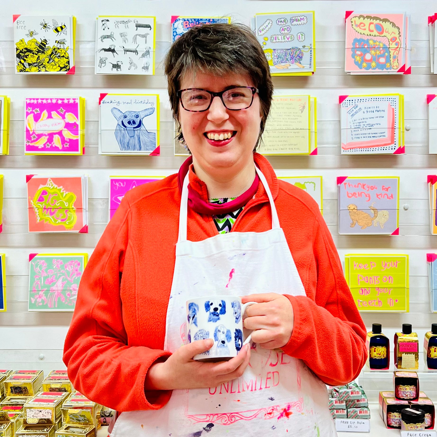 Female artist holding Blue Dogs, Fine Bone China Mug with dog drawings