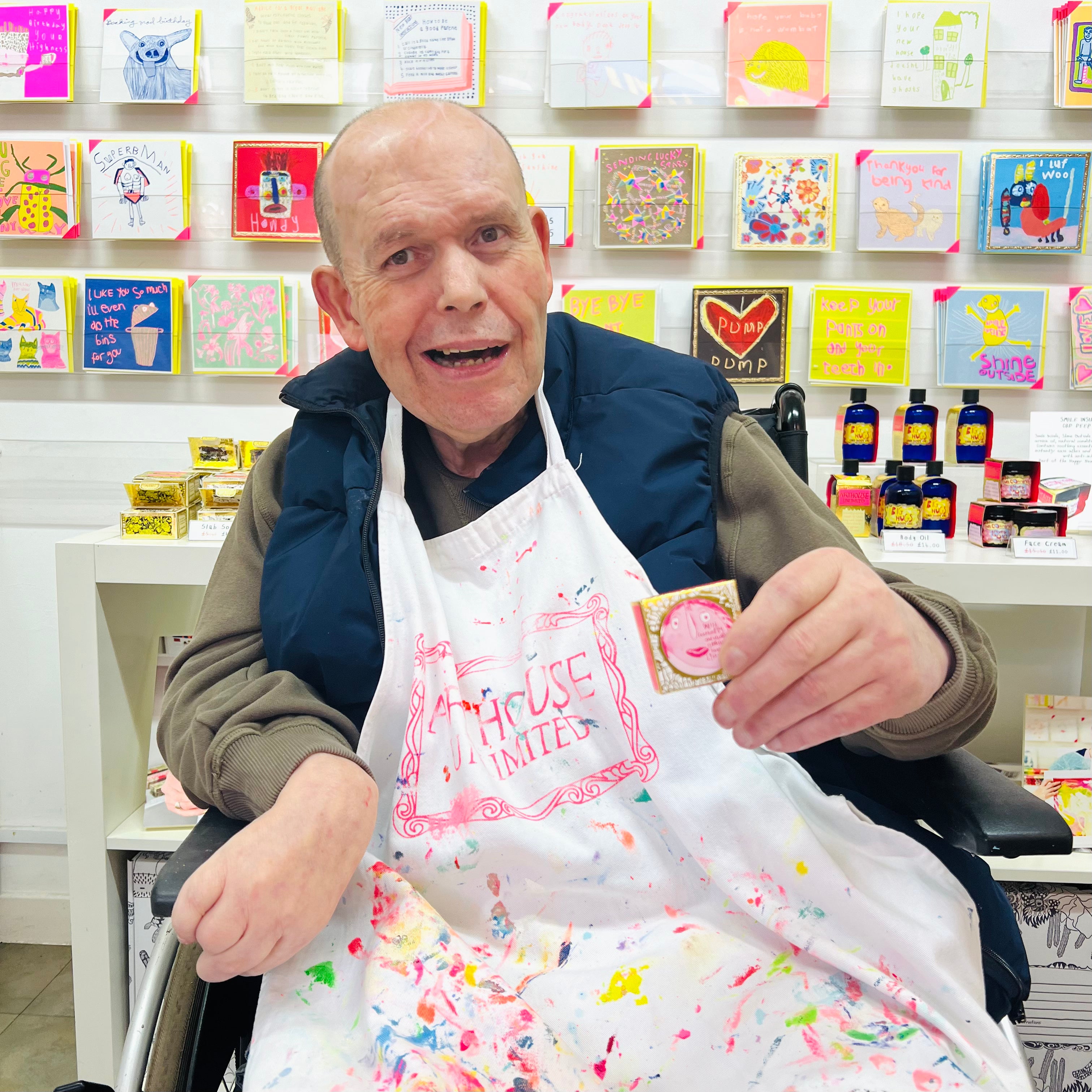 Male artist holding Lady Muck, Wild Raspberry & Vanilla Lip Balm