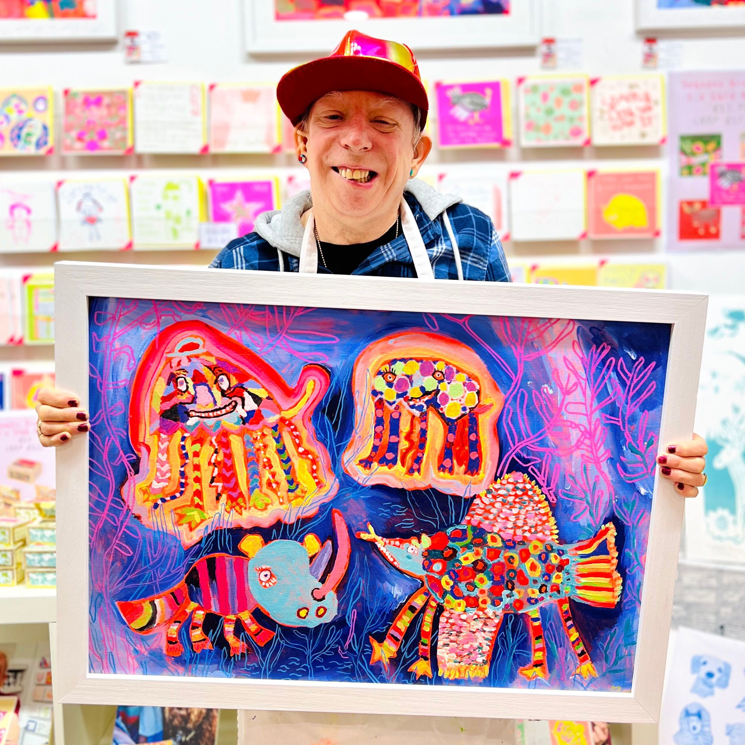 Male artist holding Bright coloured hand painted strange animal design called Jelly Hippo Crock-a-doo