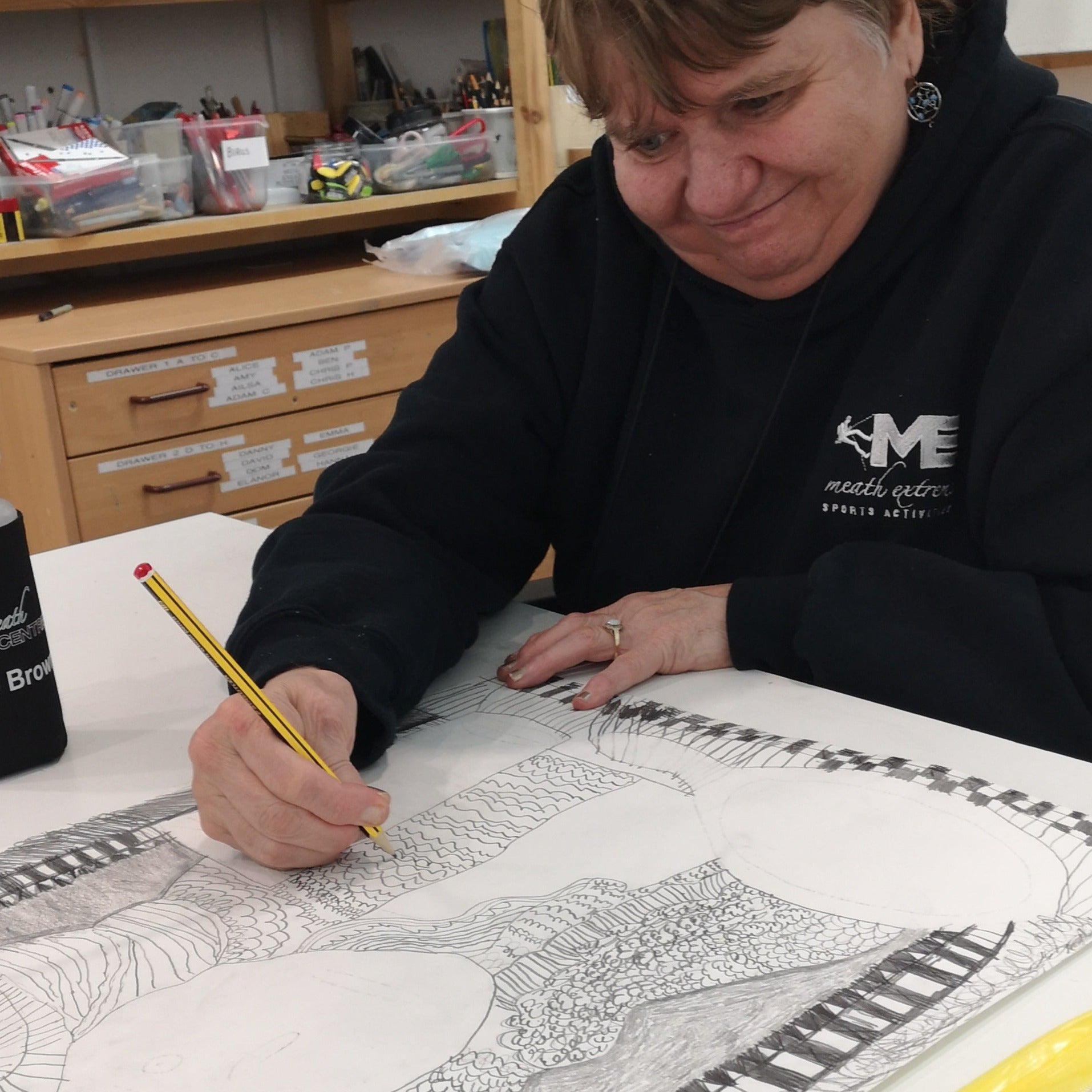 Female artist drawing a woman in pencil
