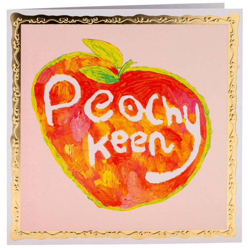 Bright painting on a peach with the text 'Peachy keen' written in white.