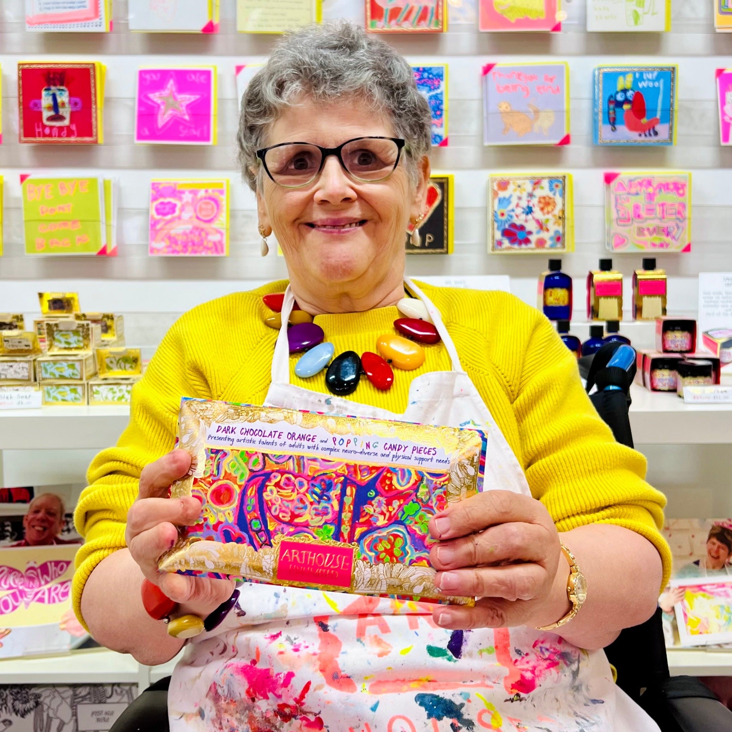 Female artist holding Rhino in Bloom chocolate bar with orange and popping candy pieces