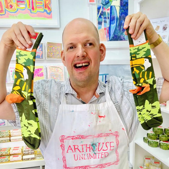 Male artist holding a pair of Amazon, Organic Cotton Socks