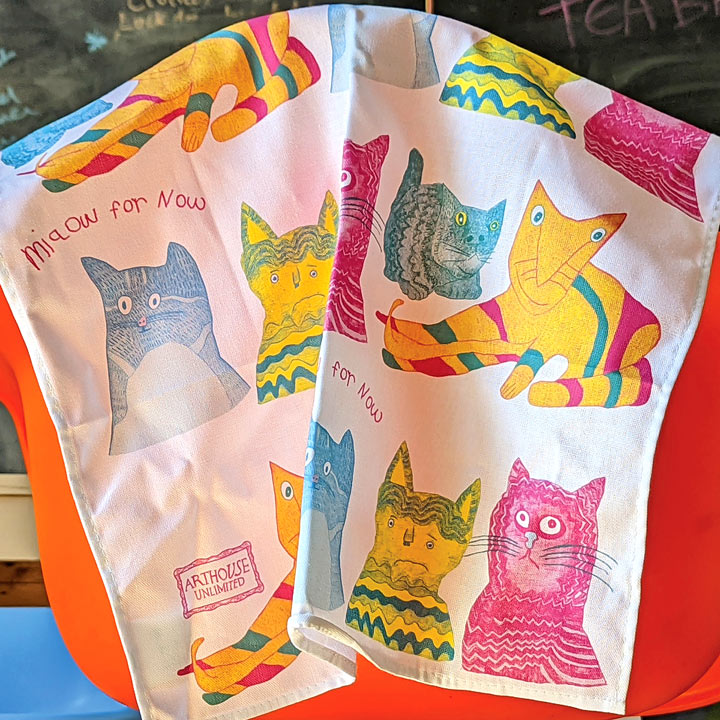Miaow for Now, 100% Organic Cotton Tea Towel over the back of a chair