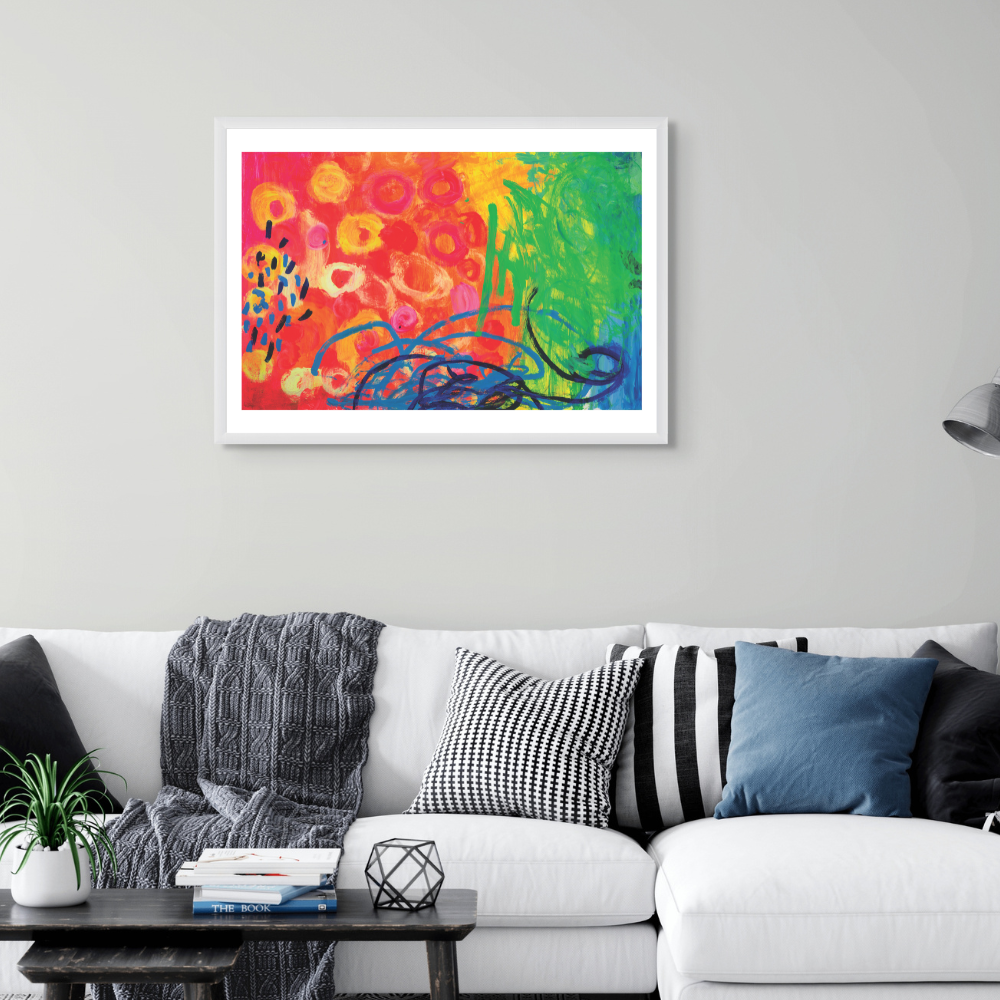 Colorful abstract painting on a gray wall above a white sofa with decorative pillows.
