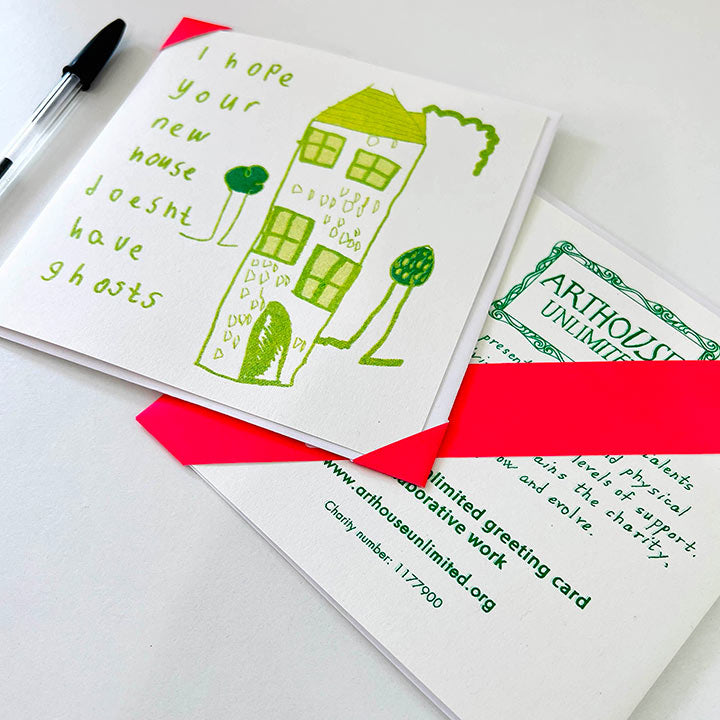  A white card featuring a green hand drawn image of a house with the words I hope your new house doesn't have ghosts