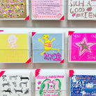 A card rack featuring A blue pink and yellow hand drawn character with the words smile inside shine outside