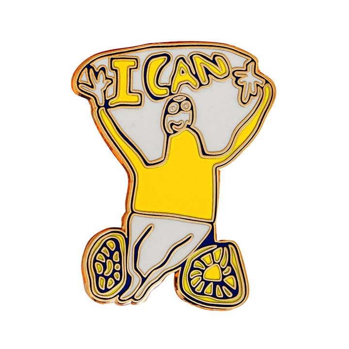 A pin badge featuring a wheelchair user with the words 'I can" in white and yellow 