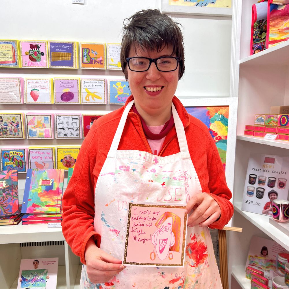 Artist Maria Travis proudly holds her designed greetings card.