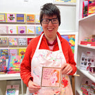 Artist Maria Travis proudly holds her designed greetings card.