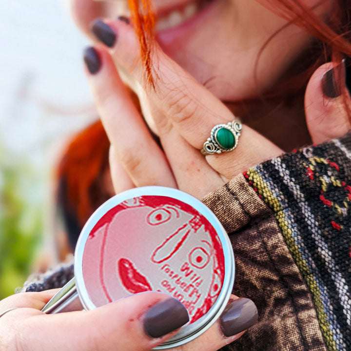 Young girl holding a tin of Lady Muck, Lip Balm, Wild Raspberry & Vanilla