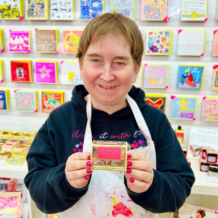 Female artist holding Gorillas in the Musk, triple milled organic soap.