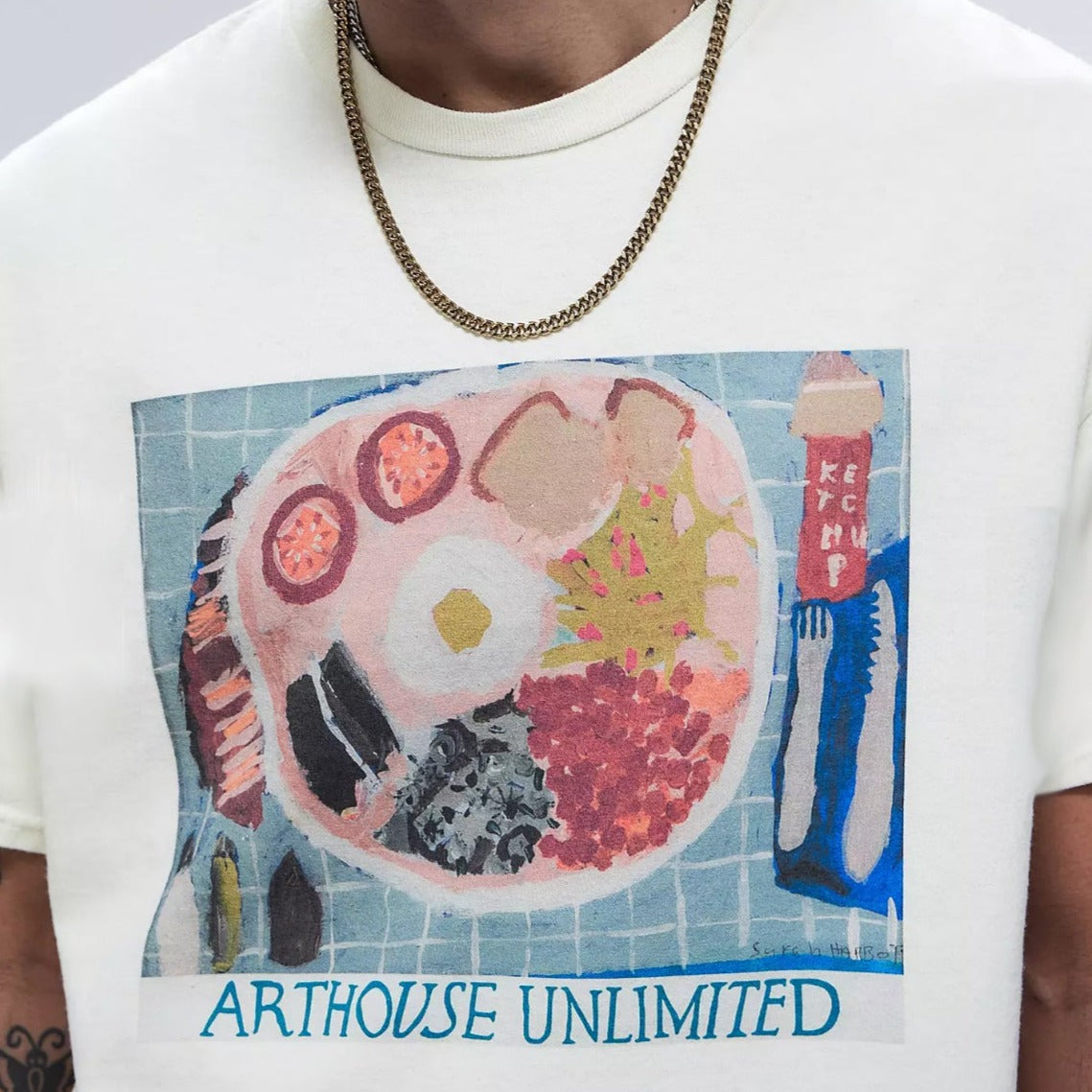 Male model wearing a arthouse unlimited white t-shirt with a hand painted picture of a fry up breakfast  close up